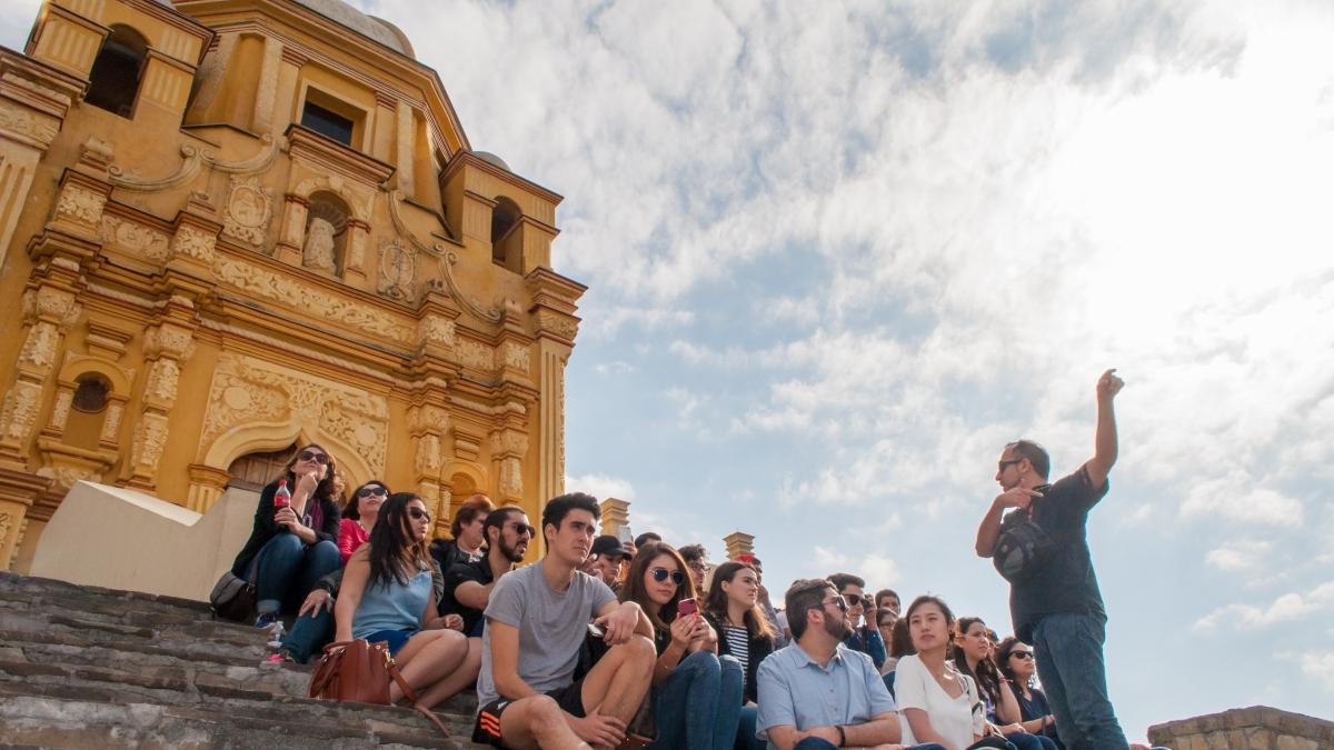 Professor speaks to a group of Trinity students gathered on the steps of the Cerro del Obispado, a famous landmark in Monterrey, Mexico